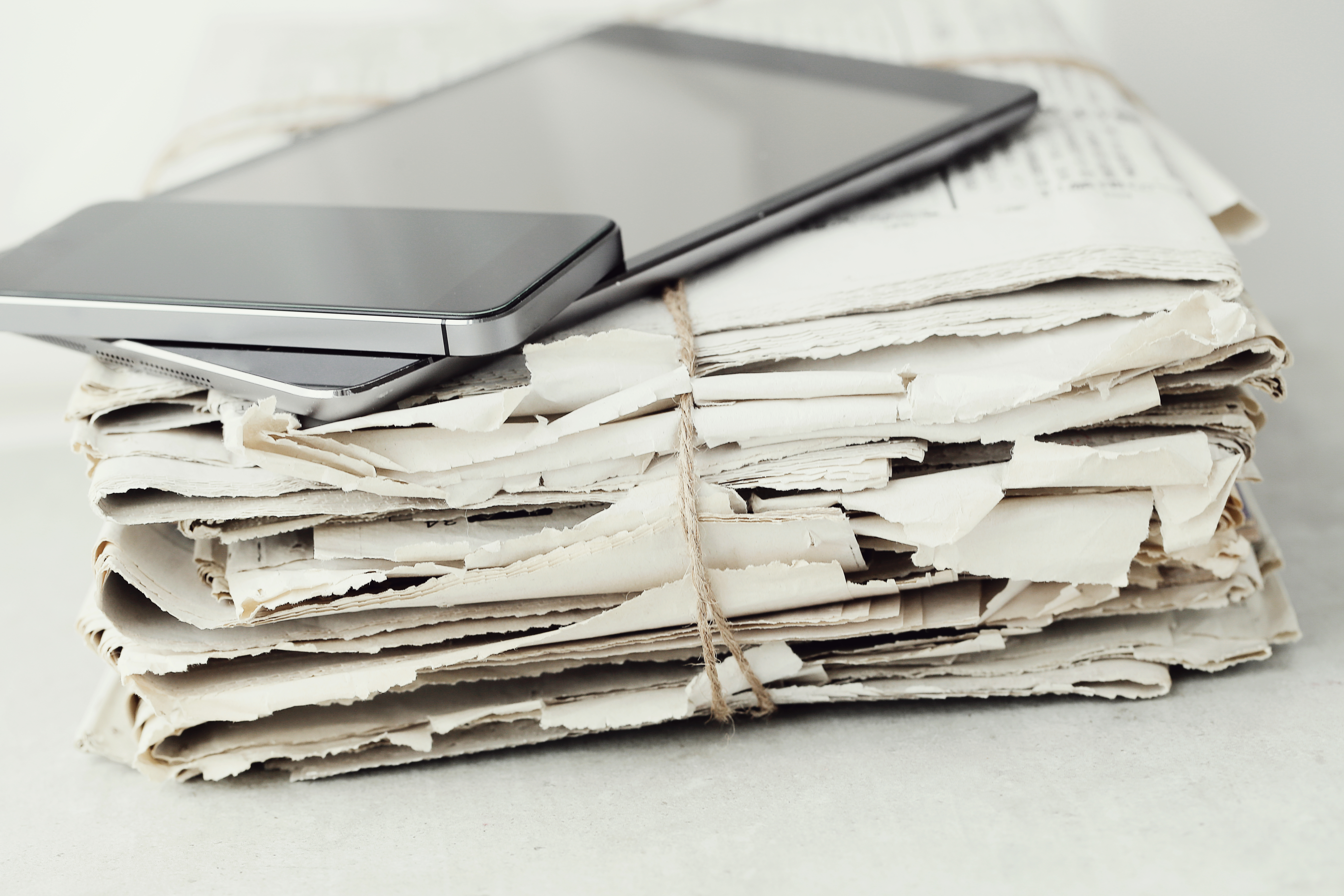 stack-newspapers-with-digital-tablet-smartphone